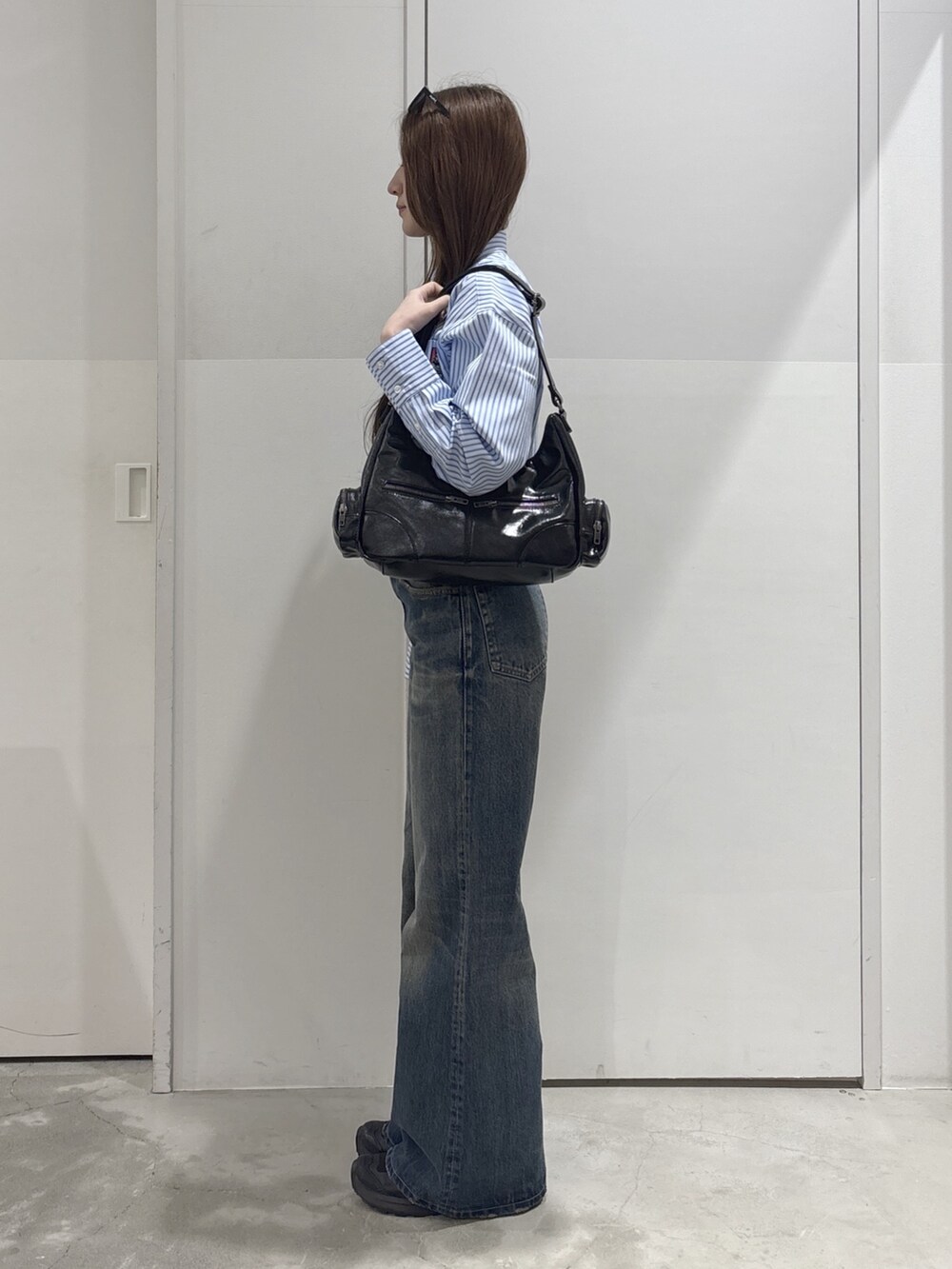ブルー系のデニムパンツ、ブルー系のシャツ/ブラウス、ホワイト系のタンクトップを着用したレディースの春コーディネートの2枚目の写真