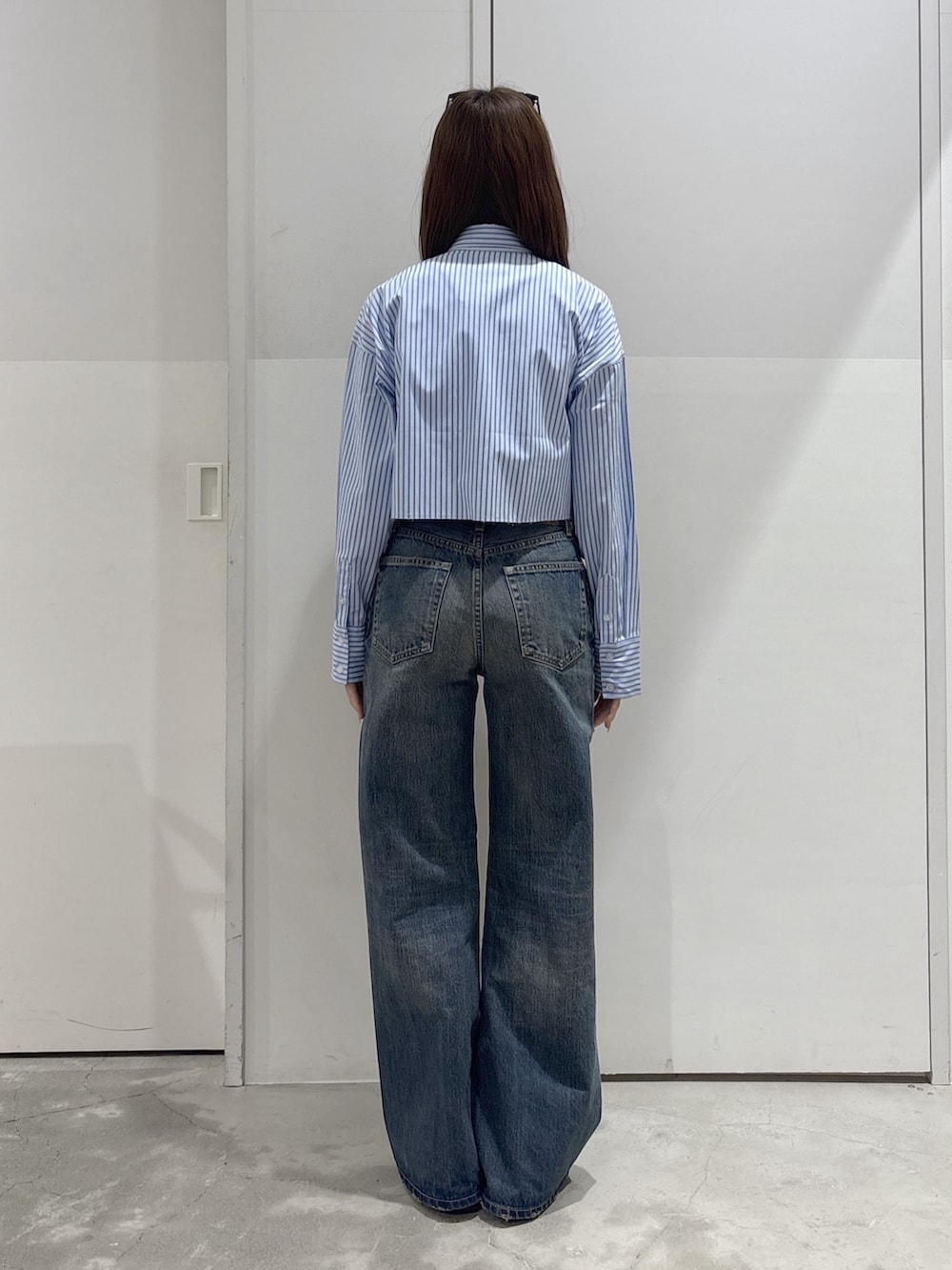 ブルー系のデニムパンツ、ブルー系のシャツ/ブラウス、ホワイト系のタンクトップを着用したレディースの春コーディネートの3枚目の写真