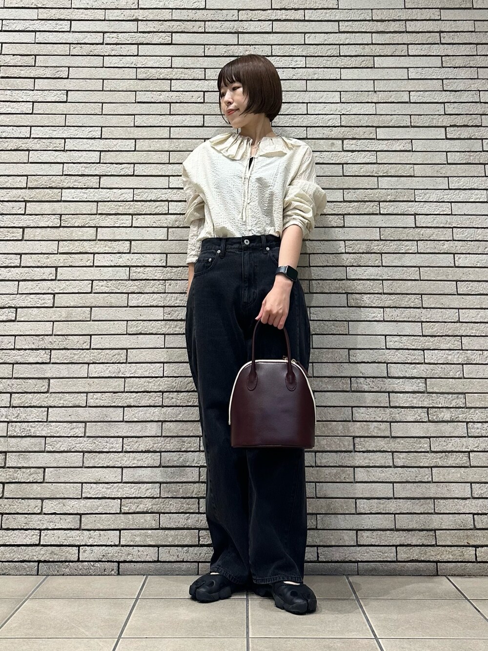 ホワイト系のシャツ/ブラウス、ブラック系のデニムパンツ、レッド系のハンドバッグを着用したレディースの秋コーディネートの2枚目の写真
