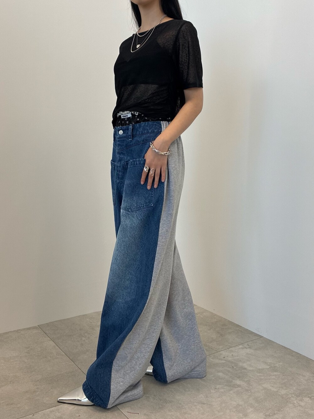 ブルー系のデニムパンツ、ブラック系のTシャツ/カットソー、シルバー系のネックレスを着用したレディースの夏コーディネートの3枚目の写真