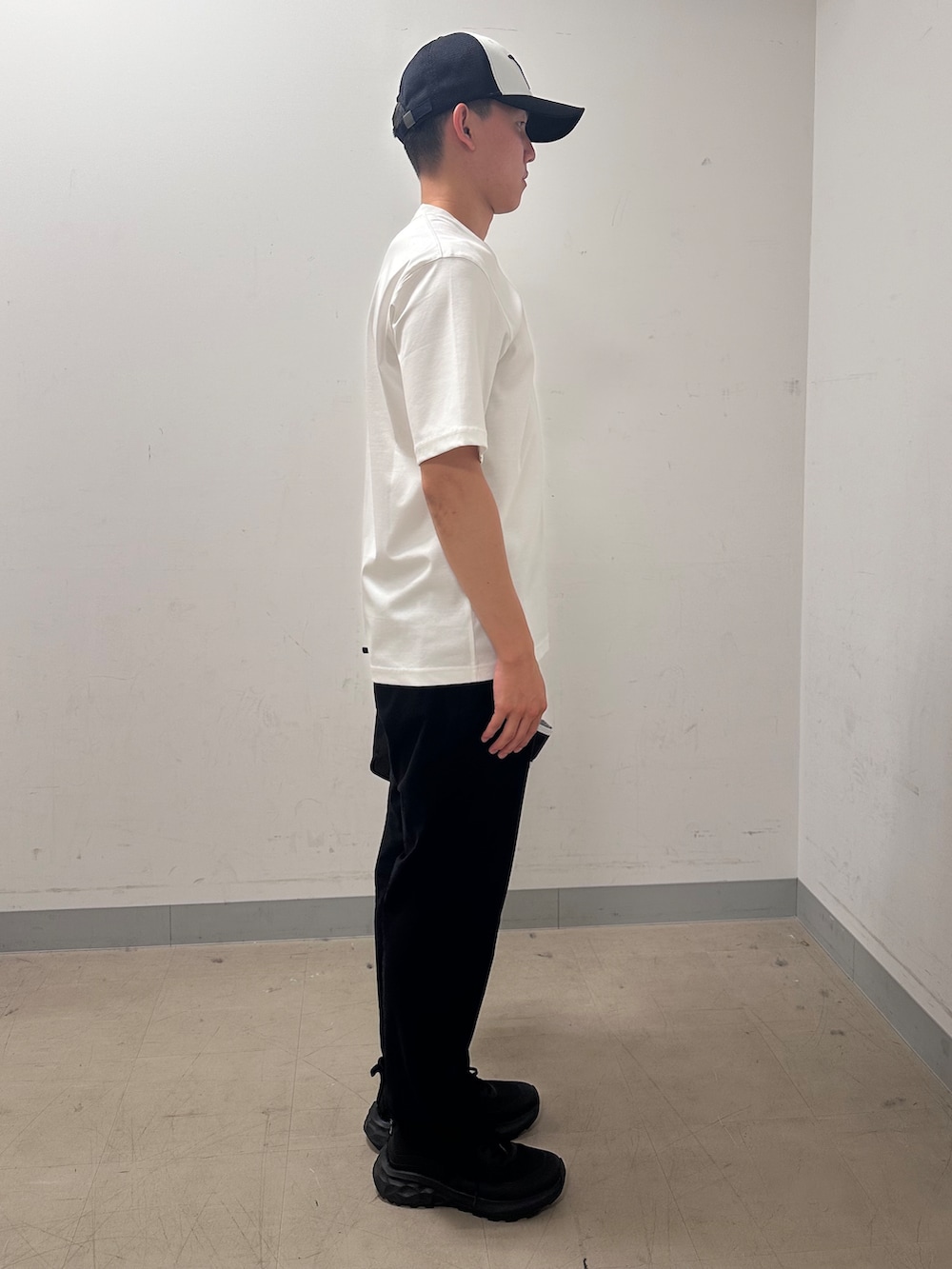 ホワイト系のTシャツ/カットソー、ブラック系のその他パンツ、ブラック系のキャップを着用したメンズの夏コーディネートの4枚目の写真