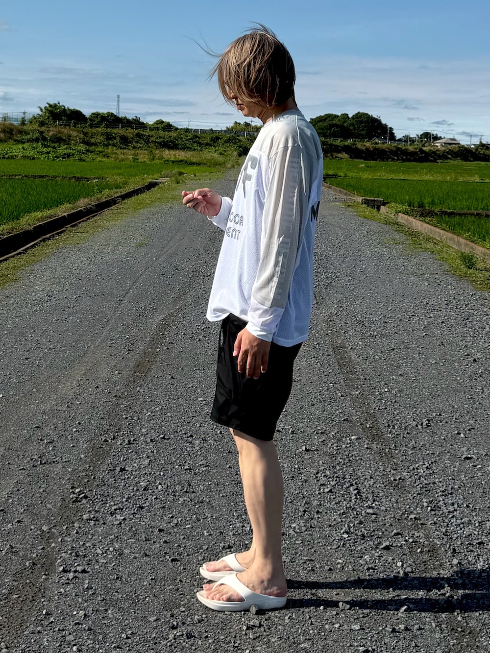 ホワイト系のTシャツ/カットソー、ブラック系のその他パンツ、ホワイト系のサンダルを着用したメンズの夏コーディネートの2枚目の写真