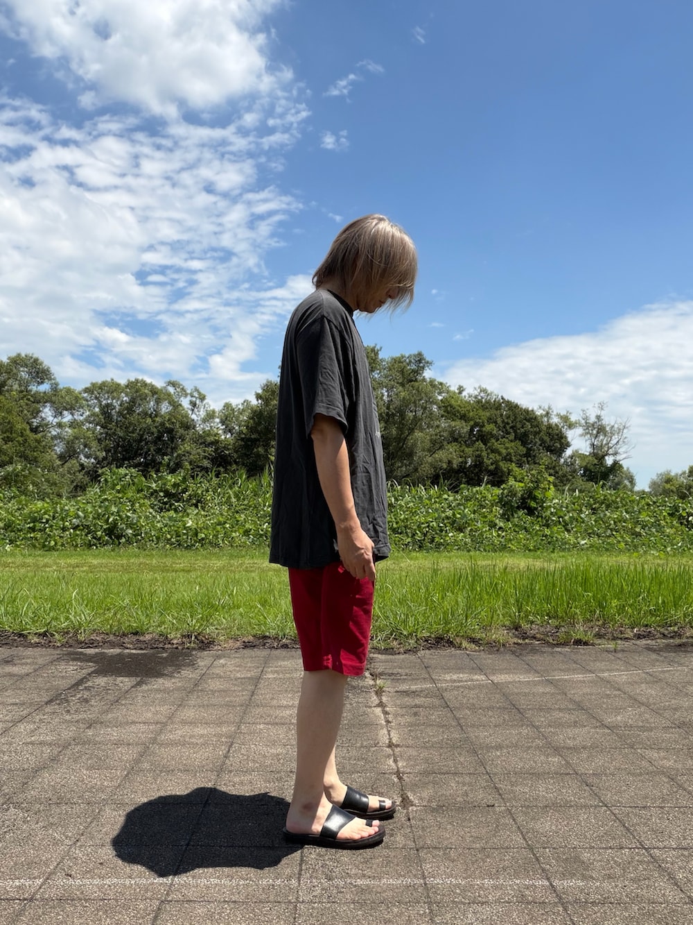 ブラック系のTシャツ/カットソー、レッド系のパンツを着用したメンズの夏コーディネートの2枚目の写真