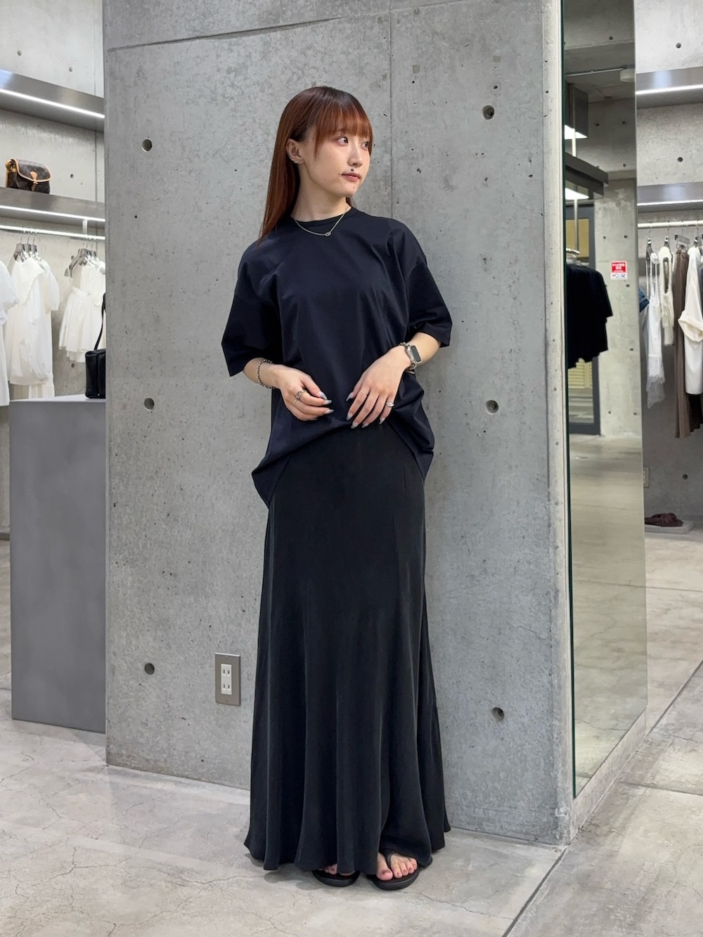 ブルー系のTシャツ/カットソー、ブラック系のスカート、ブラック系のサンダルを着用したレディースの夏コーディネートの2枚目の写真