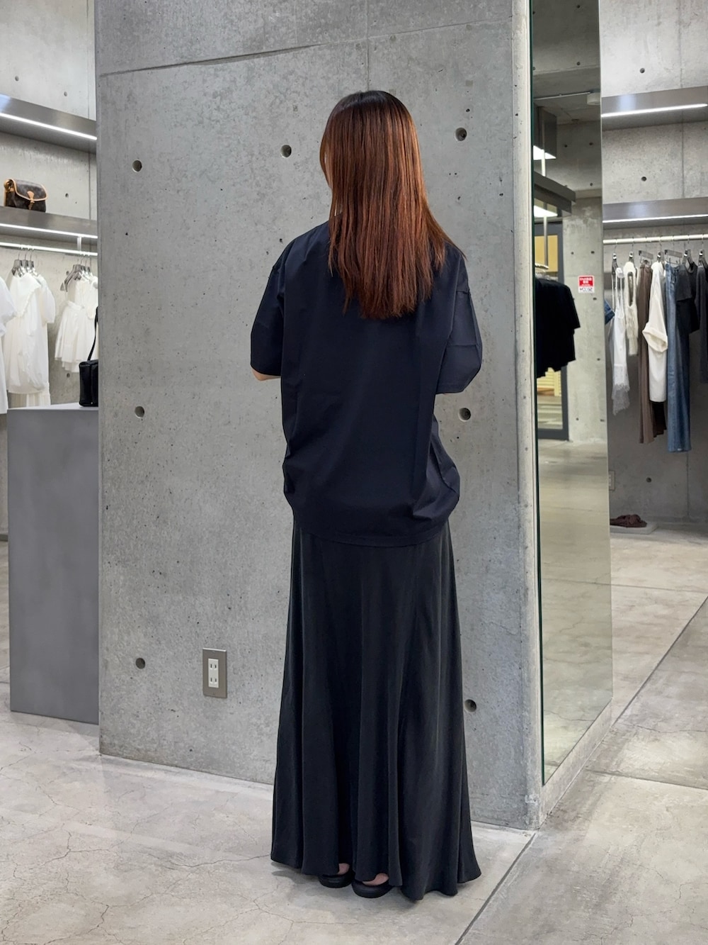 ブルー系のTシャツ/カットソー、ブラック系のスカート、ブラック系のサンダルを着用したレディースの夏コーディネートの4枚目の写真