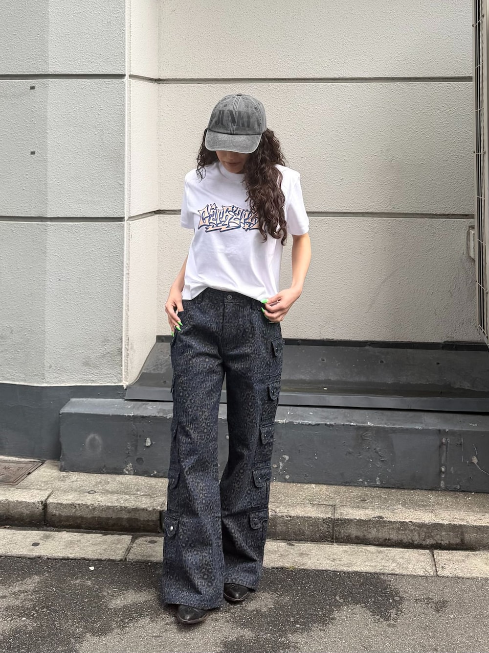 ブルー系のその他パンツ、ホワイト系のTシャツ/カットソー、ブラック系のキャップを着用したレディースの夏コーディネートの2枚目の写真