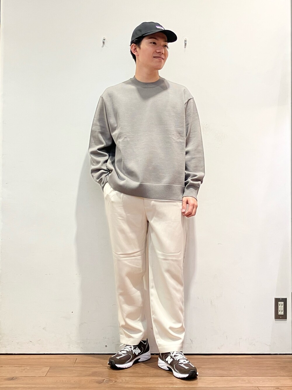 ブラウン系のその他アウター、ブラウン系のニット/セーター、ホワイト系のパンツを着用したメンズの秋コーディネートの6枚目の写真