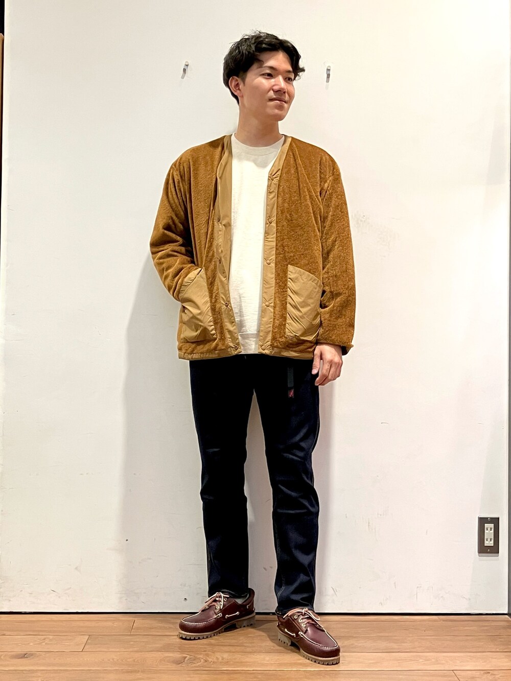 ブラウン系のその他アウター、ブルー系のその他パンツ、レッド系のスニーカーを着用したメンズの秋コーディネートの4枚目の写真