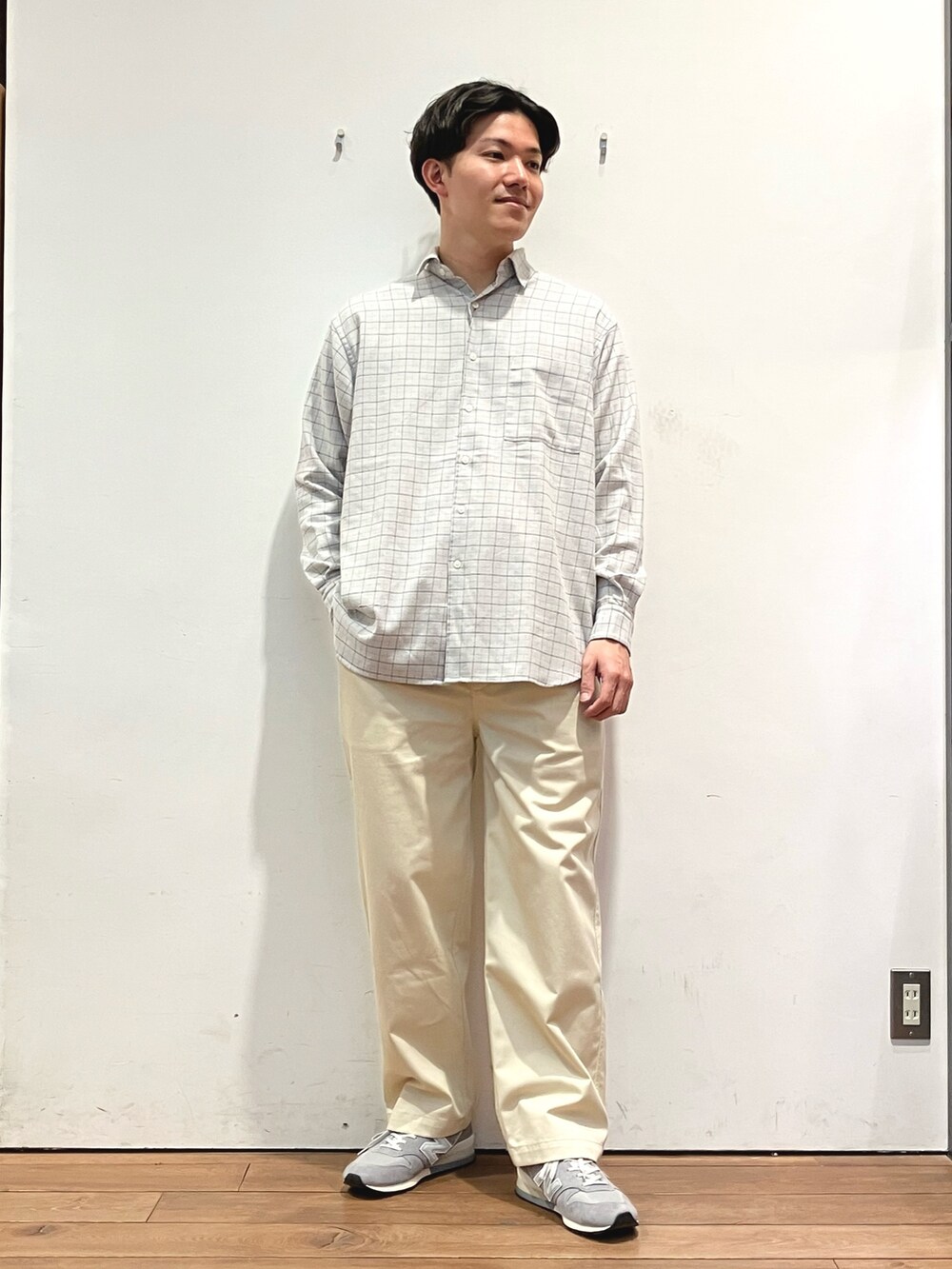 グリーン系のカーディガン/ボレロ、グレー系のシャツ/ブラウス、ホワイト系のチノパンツを着用したメンズの冬コーディネートの4枚目の写真