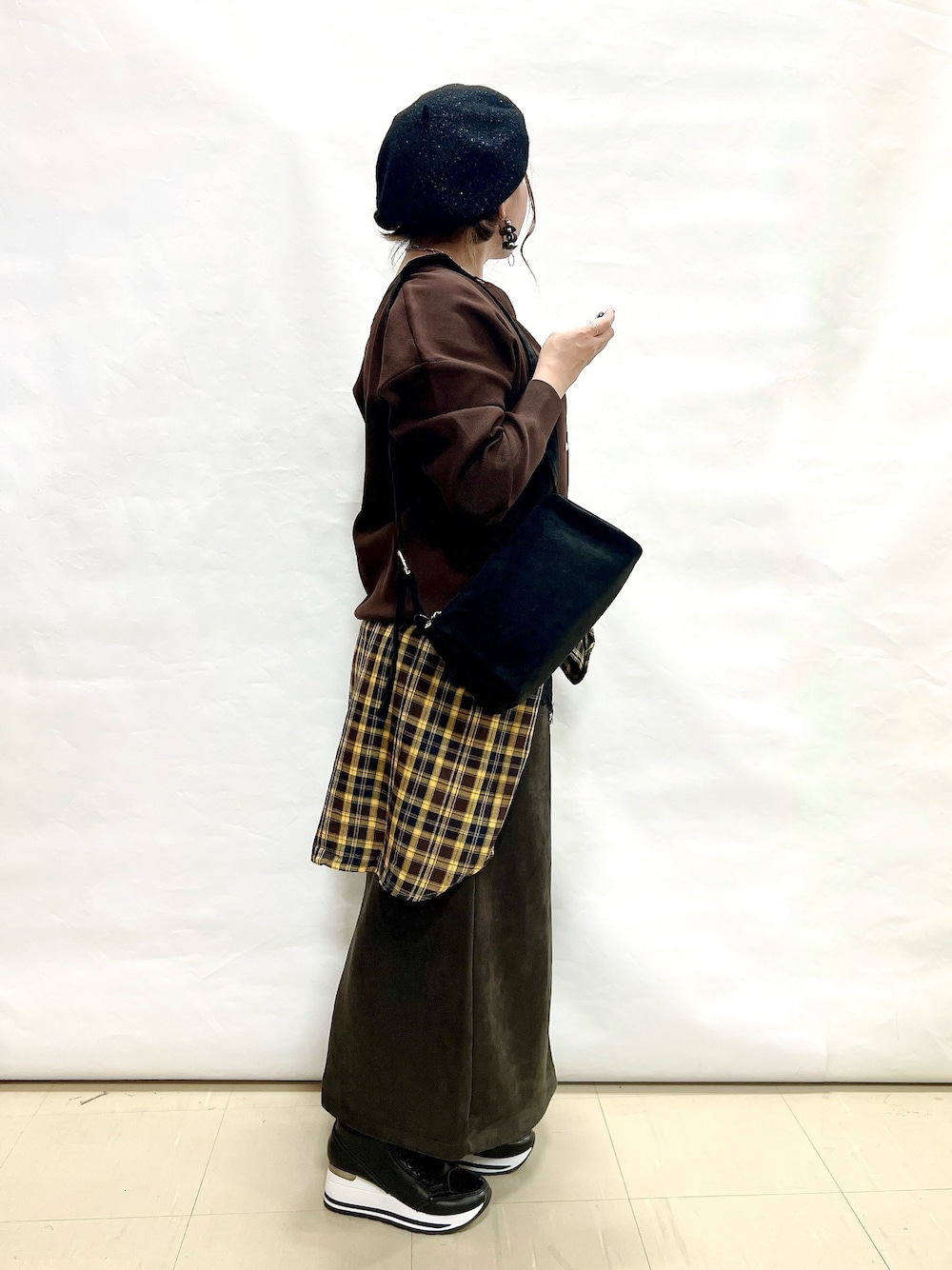 ブラウン系のカーディガン/ボレロ、イエロー系のシャツ/ブラウス、ブラック系のTシャツ/カットソーを着用したレディースの秋コーディネートの2枚目の写真