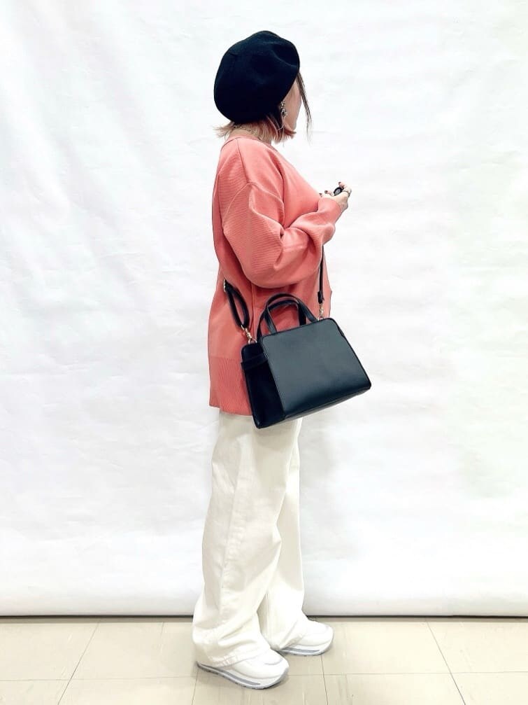 ピンク系のニット/セーター、ホワイト系のデニムパンツ、ホワイト系のスニーカーを着用したレディースの冬コーディネートの2枚目の写真