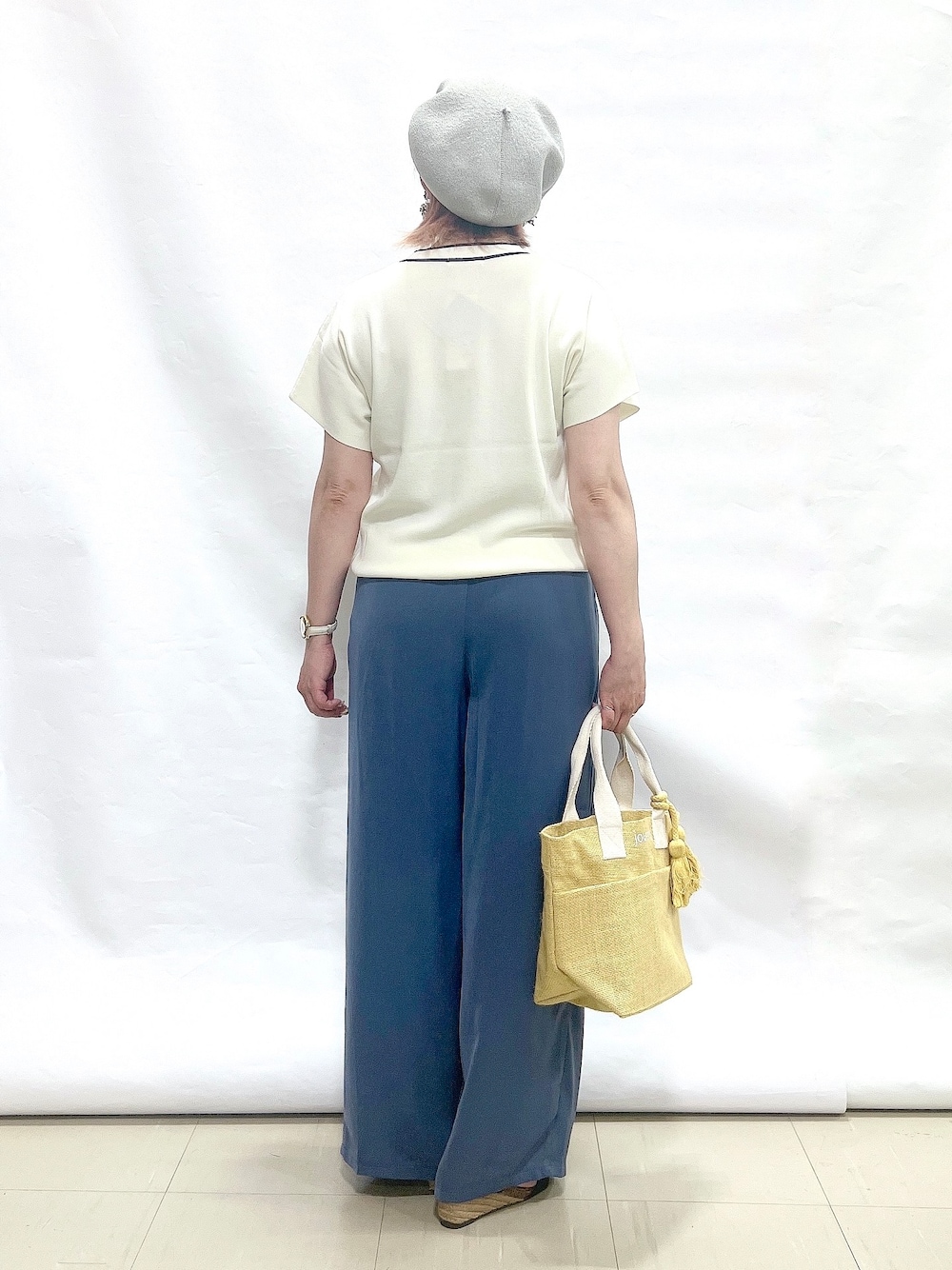 ホワイト系のニット/セーター、ブルー系のその他パンツ、ブラック系のサンダルを着用したレディースの夏コーディネートの3枚目の写真