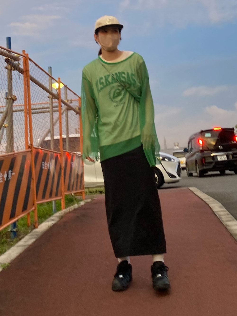 ブルー系のトートバッグ、ブラック系のスカート、ブラック系のスニーカーを着用したレディースの夏コーディネートの3枚目の写真