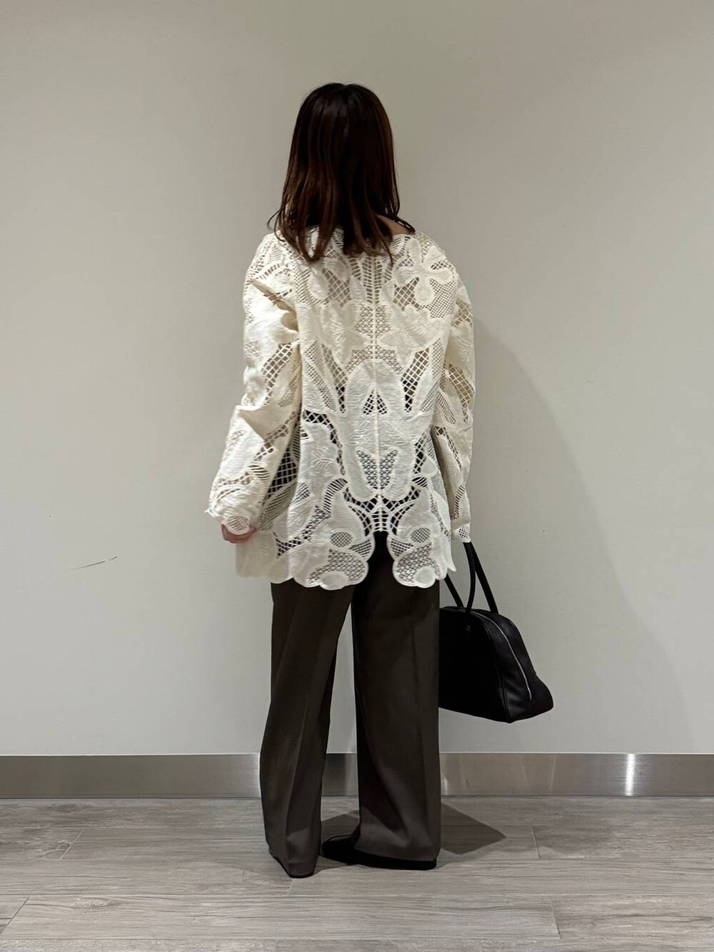 ホワイト系のキャミソール、ホワイト系のシャツ/ブラウス、ブラウン系のスラックスを着用したレディースの秋コーディネートの3枚目の写真