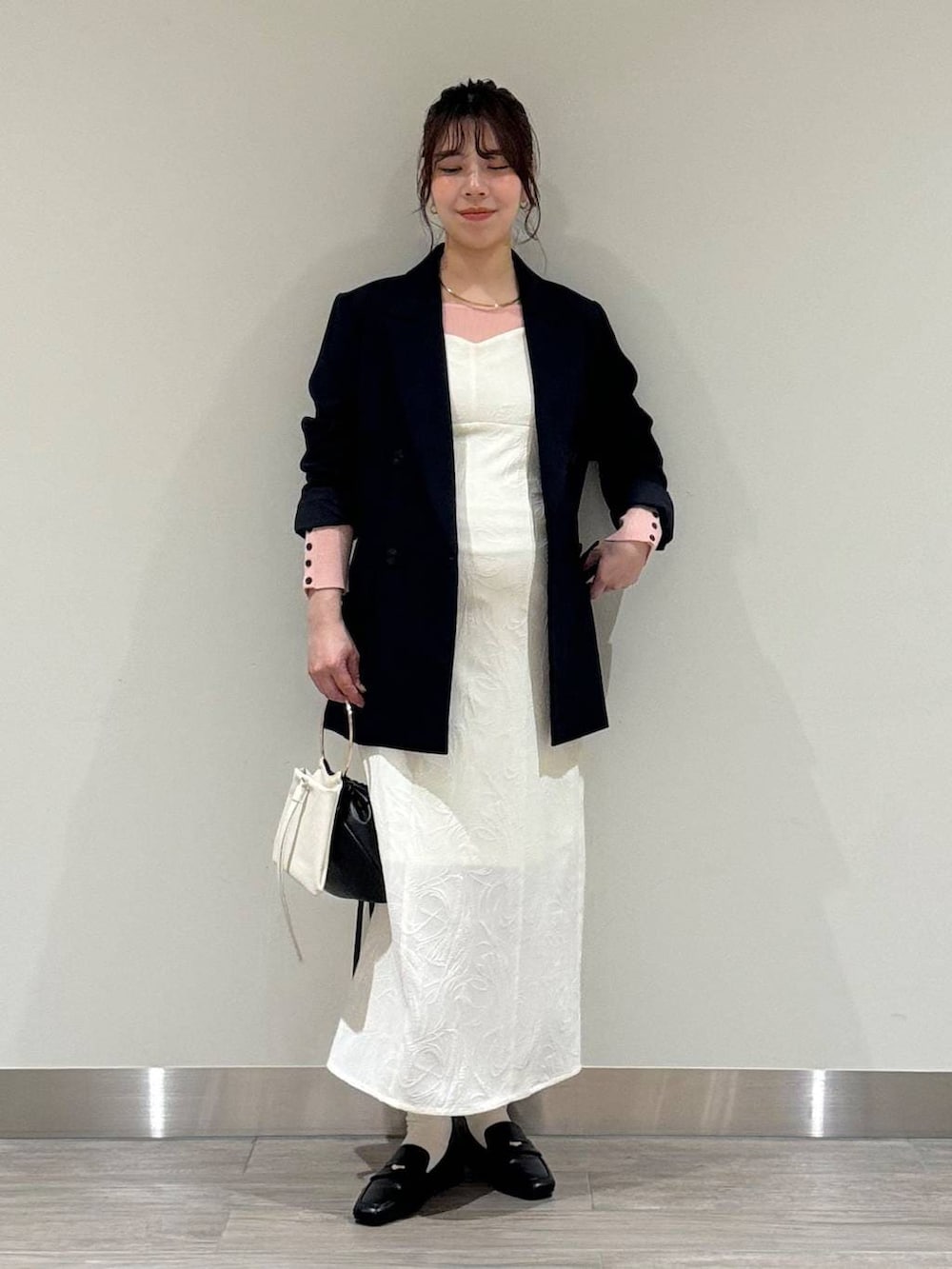 ブラック系のローファー、ブルー系のテーラードジャケット、ピンク系のニット/セーターを着用したレディースの春コーディネートの5枚目の写真