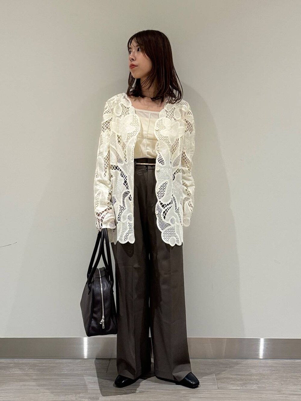 ホワイト系のキャミソール、ホワイト系のシャツ/ブラウス、ブラウン系のスラックスを着用したレディースの秋コーディネートの2枚目の写真