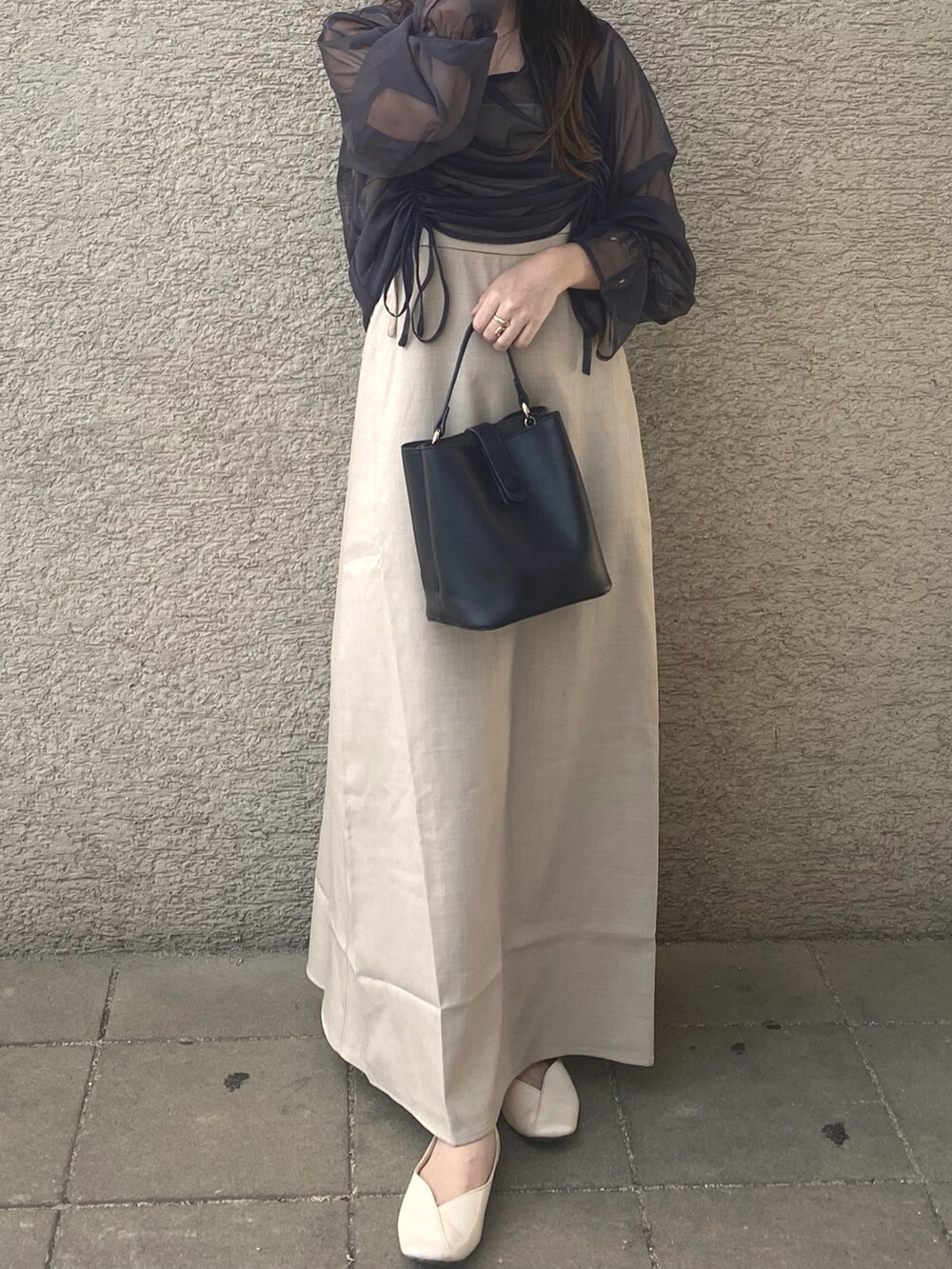 ベージュ系のワンピース、ホワイト系のパンプスを着用したレディースの秋コーディネートの3枚目の写真