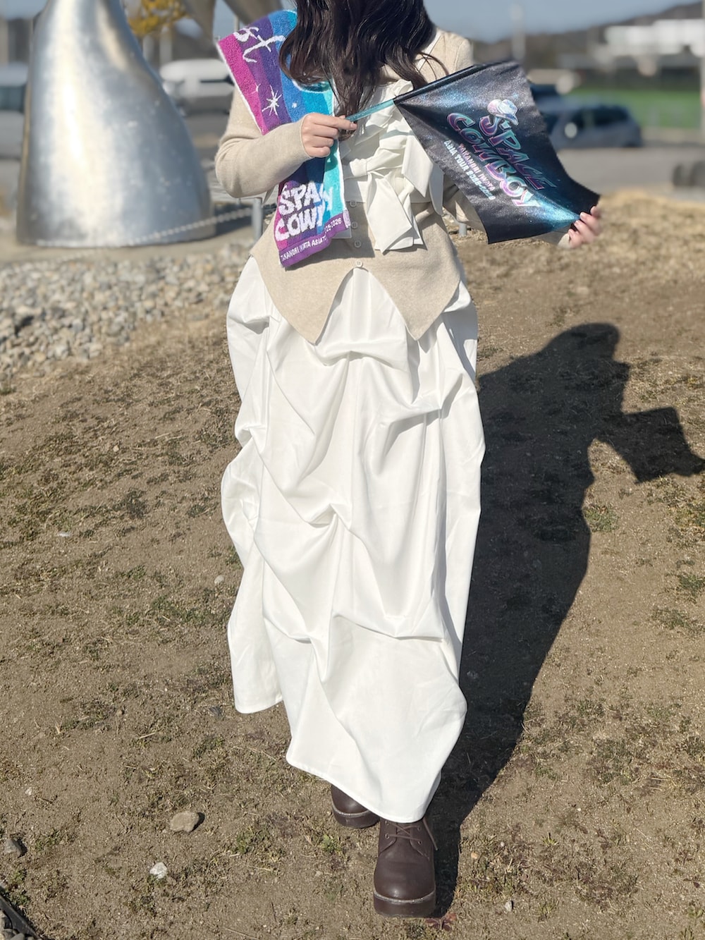 ベージュ系のニット/セーター、ホワイト系のセットアップを着用したレディースの春コーディネートの3枚目の写真