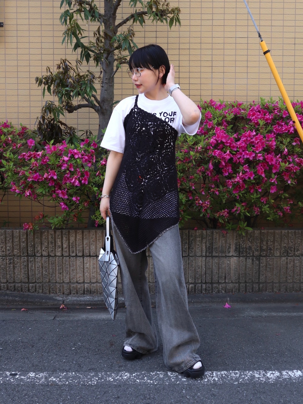 ホワイト系のTシャツ/カットソー、ブラック系のデニムパンツ、ブラック系のサンダルを着用したレディースの春コーディネートの2枚目の写真