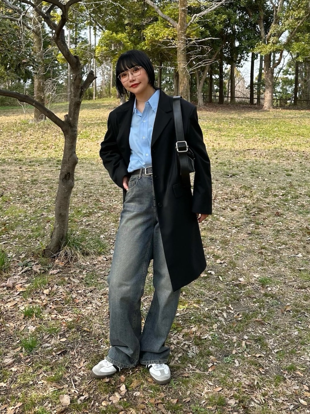 ホワイト系のスニーカー、ブルー系のデニムパンツ、ブルー系のシャツ/ブラウスを着用したレディースの春コーディネートの2枚目の写真