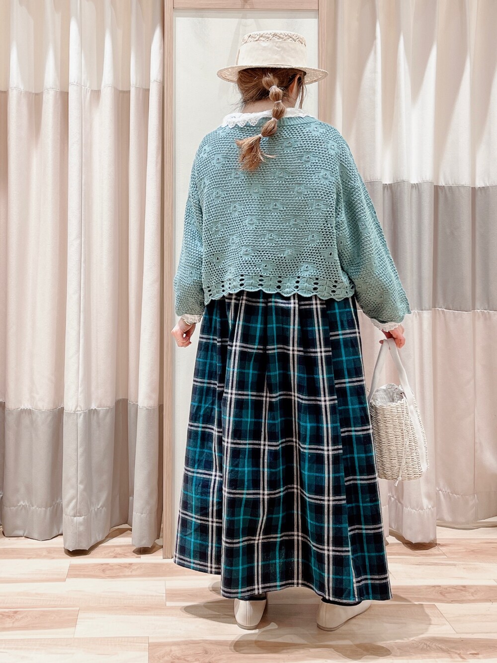 グリーン系のカーディガン/ボレロ、ホワイト系のシャツ/ブラウス、グリーン系のスカートを着用したレディースの春コーディネートの2枚目の写真