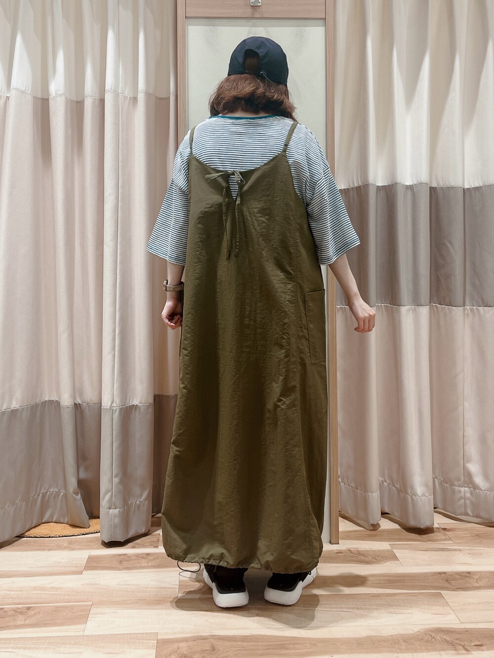 グリーン系のTシャツ/カットソー、ブラック系のワンピース/ドレス、ブラック系のサンダルを着用したレディースの夏コーディネートの2枚目の写真