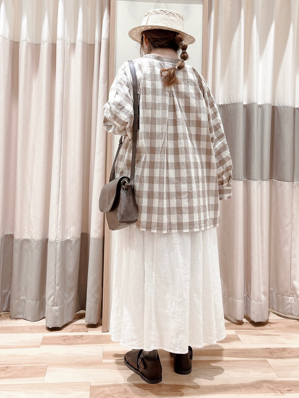 ホワイト系のTシャツ/カットソー、ベージュ系のシャツ/ブラウス、ホワイト系のスカートを着用したレディースの春コーディネートの2枚目の写真