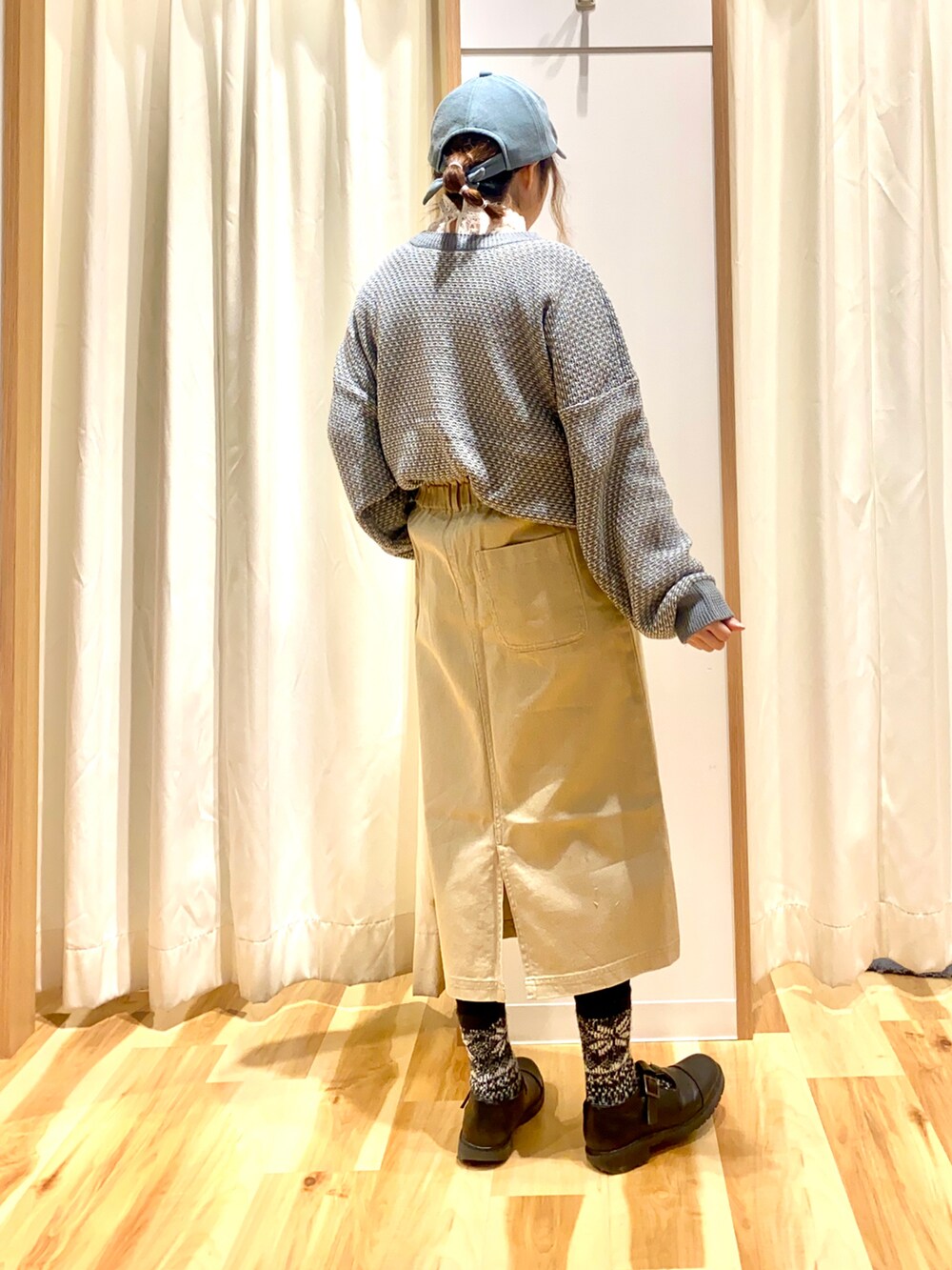 グレー系のカーディガン/ボレロ、ホワイト系のTシャツ/カットソー、ベージュ系のスカートを着用したレディースの春コーディネートの2枚目の写真