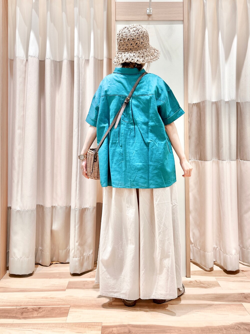 グリーン系のシャツ/ブラウス、ホワイト系のその他パンツ、ブラウン系のハンドバッグを着用したレディースの夏コーディネートの2枚目の写真