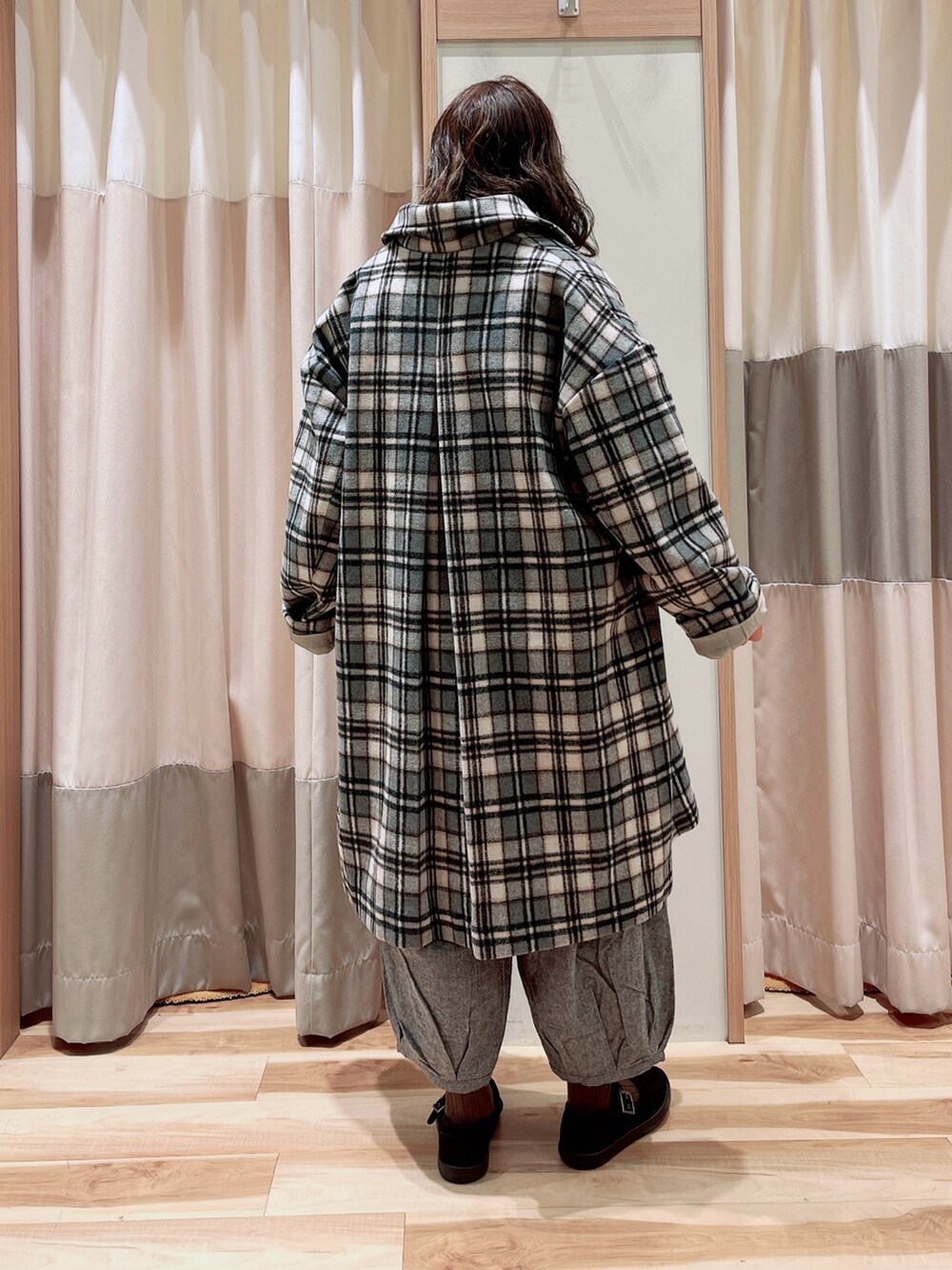 ホワイト系のTシャツ/カットソー、グレー系のステンカラーコート、グレー系のその他パンツを着用したレディースの冬コーディネートの2枚目の写真