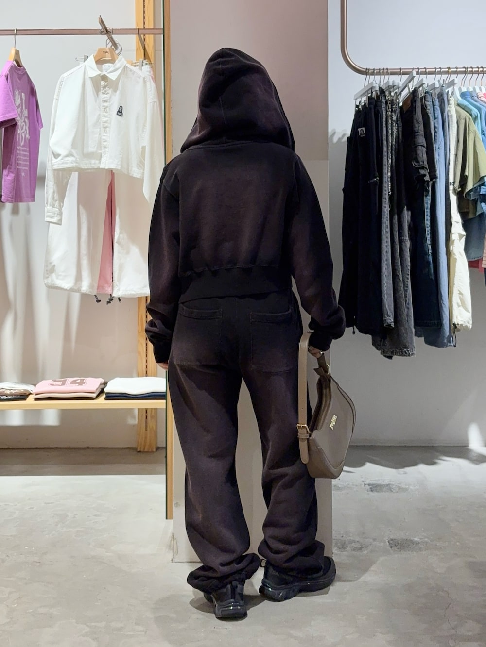 ブラック系のタンクトップ、パープル系のパーカー、パープル系のスウェットパンツを着用したレディースの春コーディネートの2枚目の写真