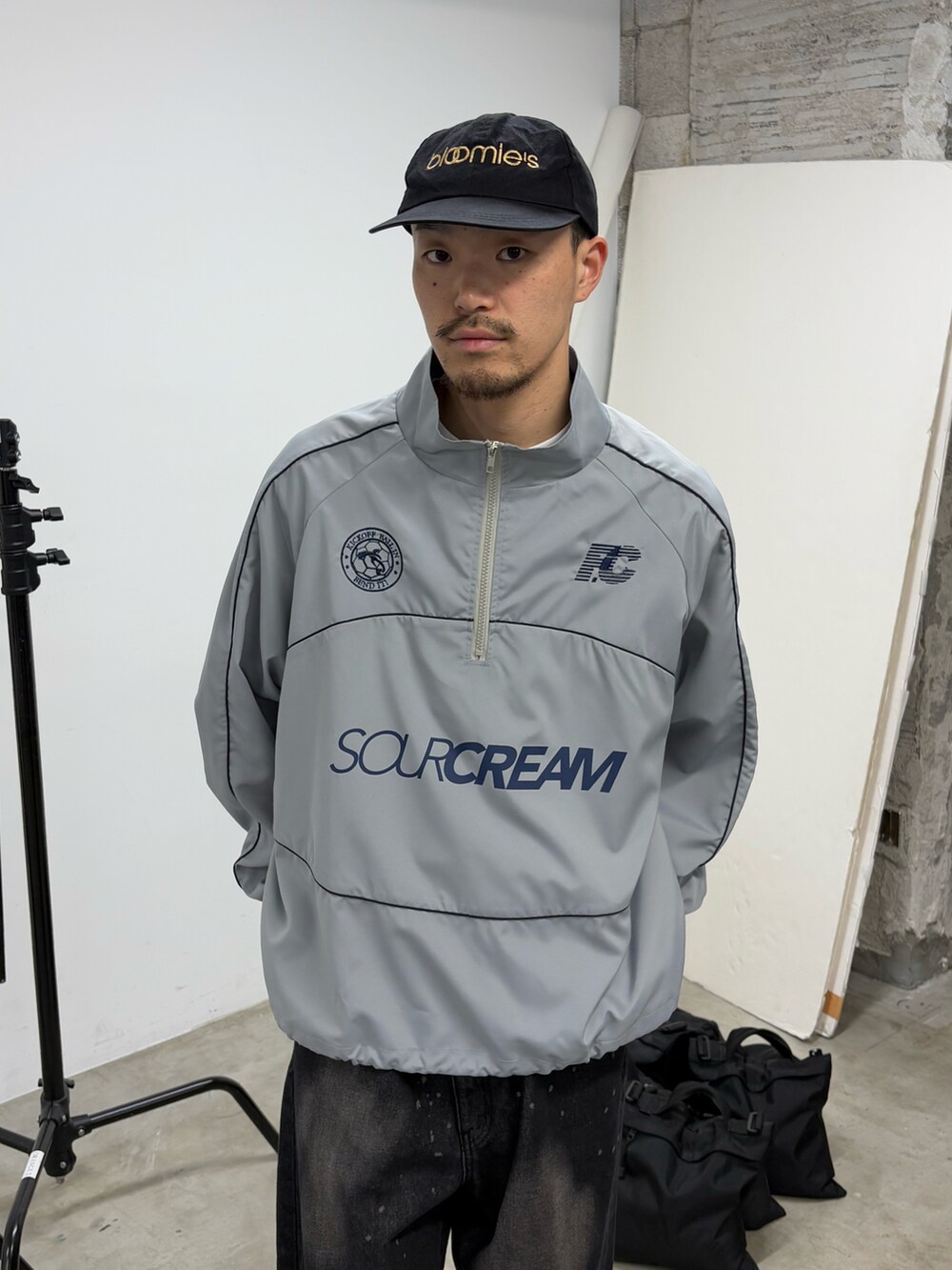 グレー系のナイロンジャケット、ブラック系のデニムパンツを着用したメンズの春コーディネートの2枚目の写真