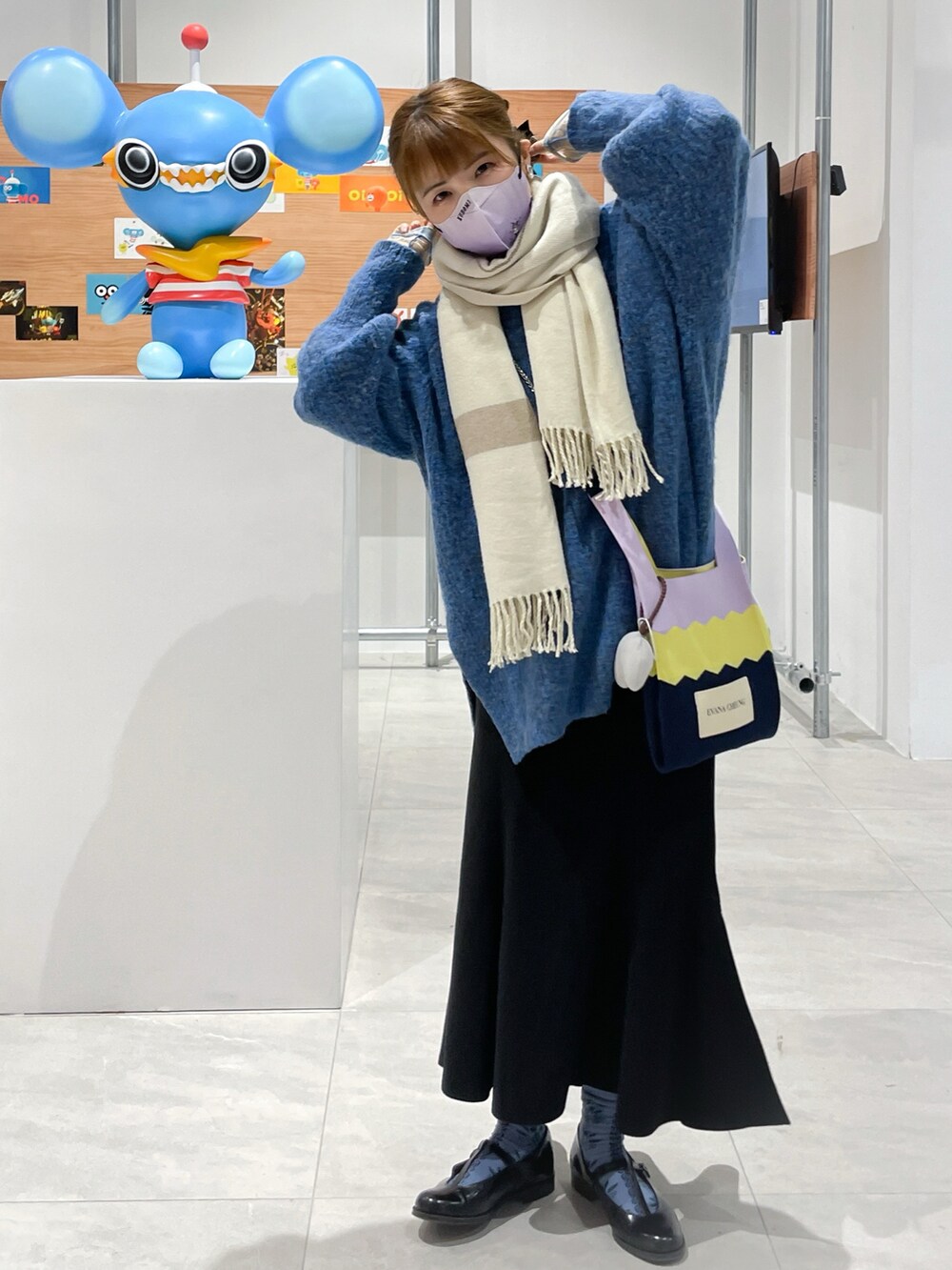 ブルー系のニット/セーター、ブラック系のスカート、ブラック系のドレスシューズを着用したレディースの冬コーディネートの3枚目の写真