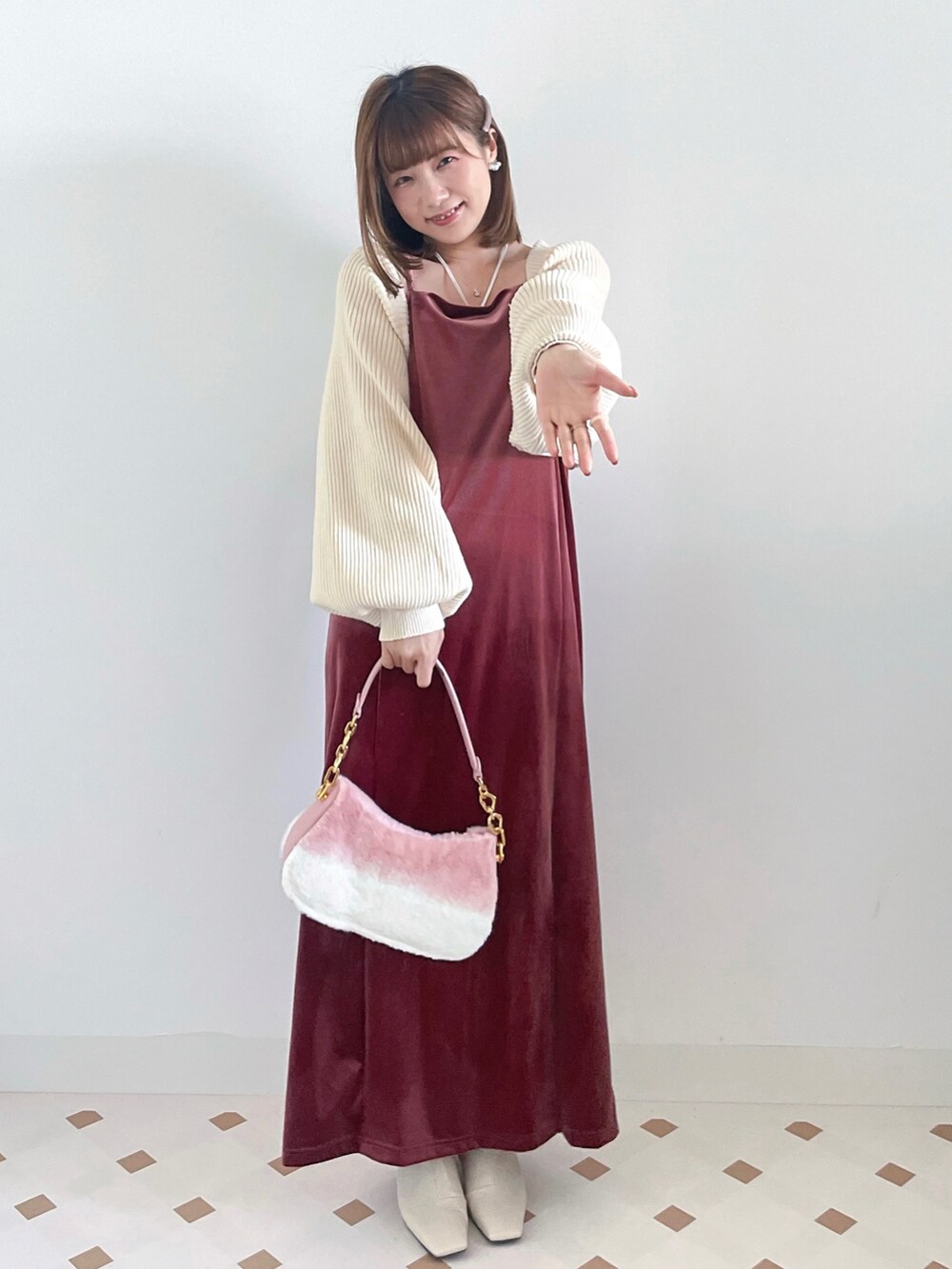 ホワイト系のカーディガン/ボレロ、ピンク系のワンピース、ホワイト系のブーツを着用したレディースの冬コーディネートの3枚目の写真