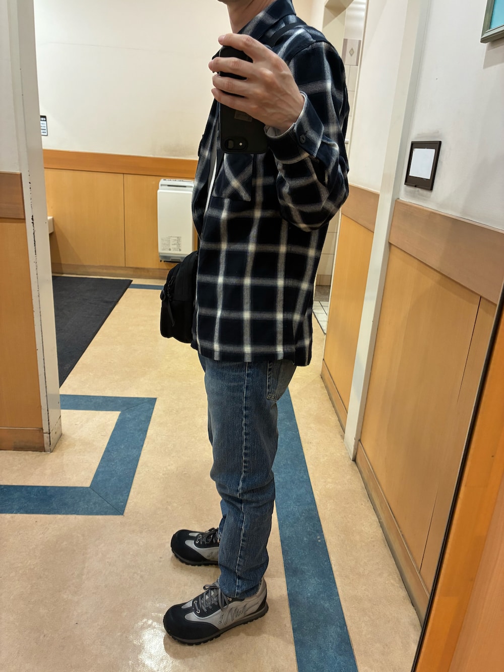 グレー系のスニーカー、ブルー系のデニムパンツ、ブラック系のシャツ/ブラウスを着用したメンズの春コーディネートの2枚目の写真