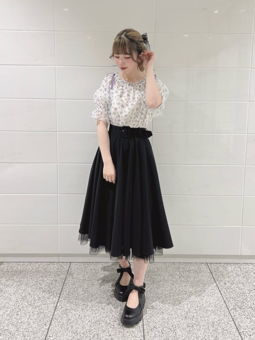 ブラック系のパンプス、ブラック系のスカート、パープル系のシャツ/ブラウスを着用したレディースの春コーディネートの2枚目の写真