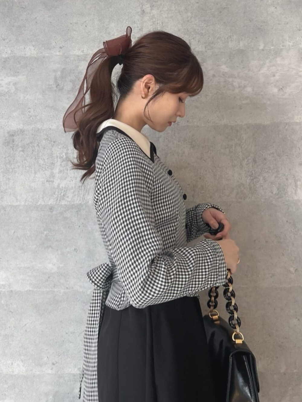 レッド系のパンプス、ブラック系のワンピースを着用したレディースの冬コーディネートの2枚目の写真