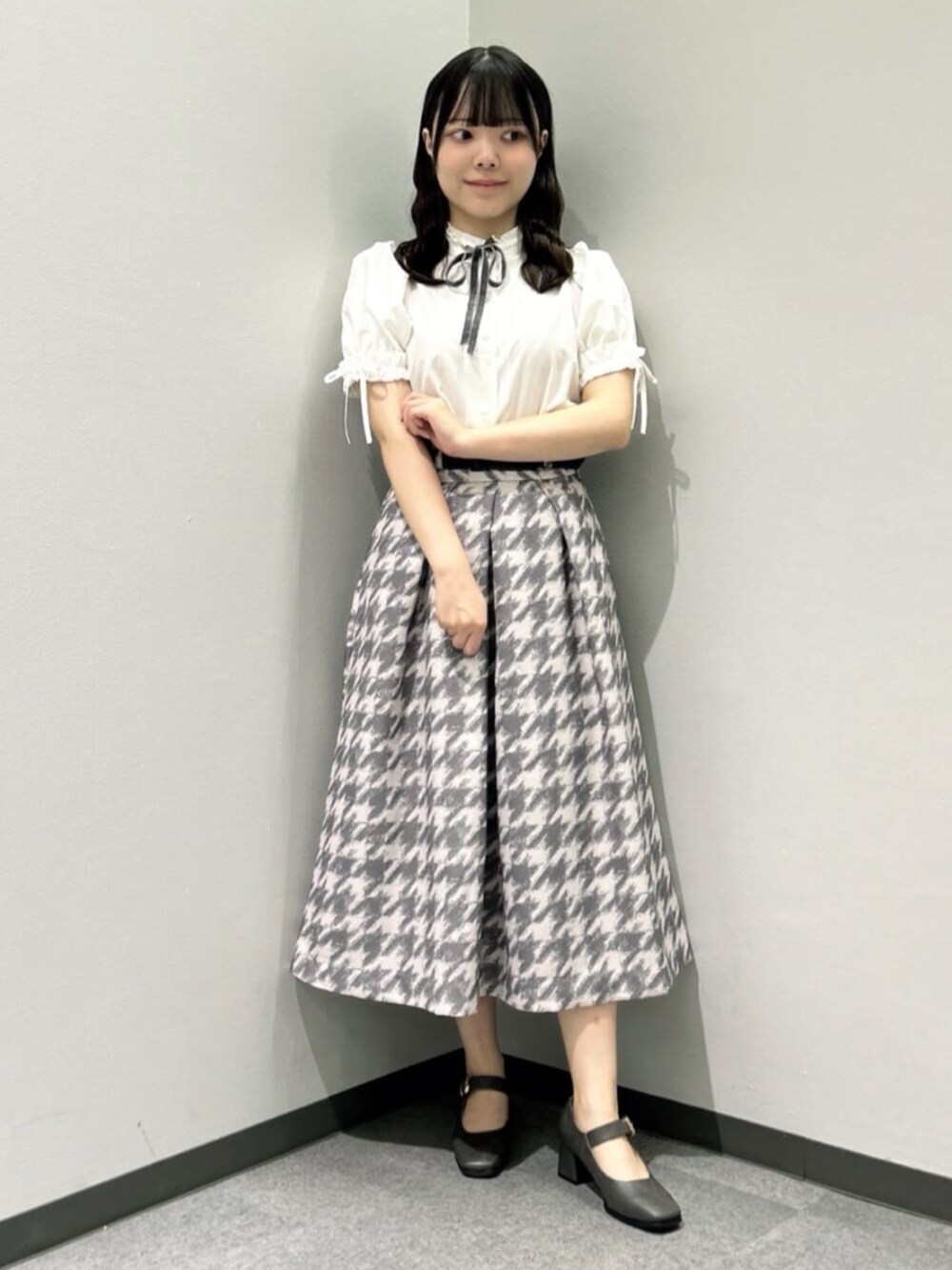 グレー系のスカート、ピンク系のセットアップ、ホワイト系のシャツ/ブラウスを着用したレディースの秋コーディネートの6枚目の写真