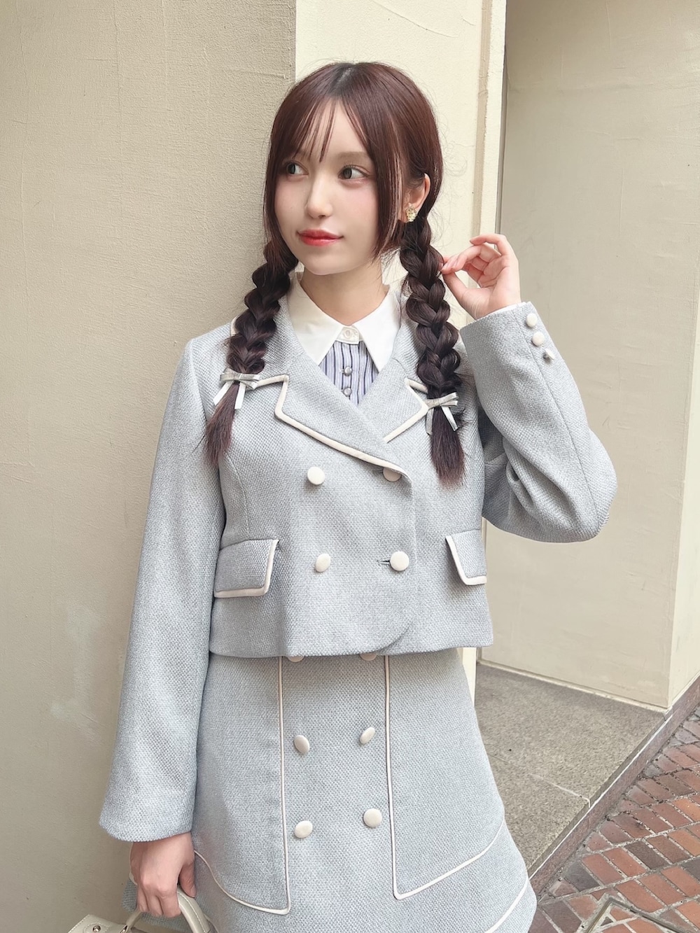 ベージュ系のハンドバッグ、ブラック系のローファー、ブルー系のセットアップを着用したレディースの冬コーディネートの2枚目の写真