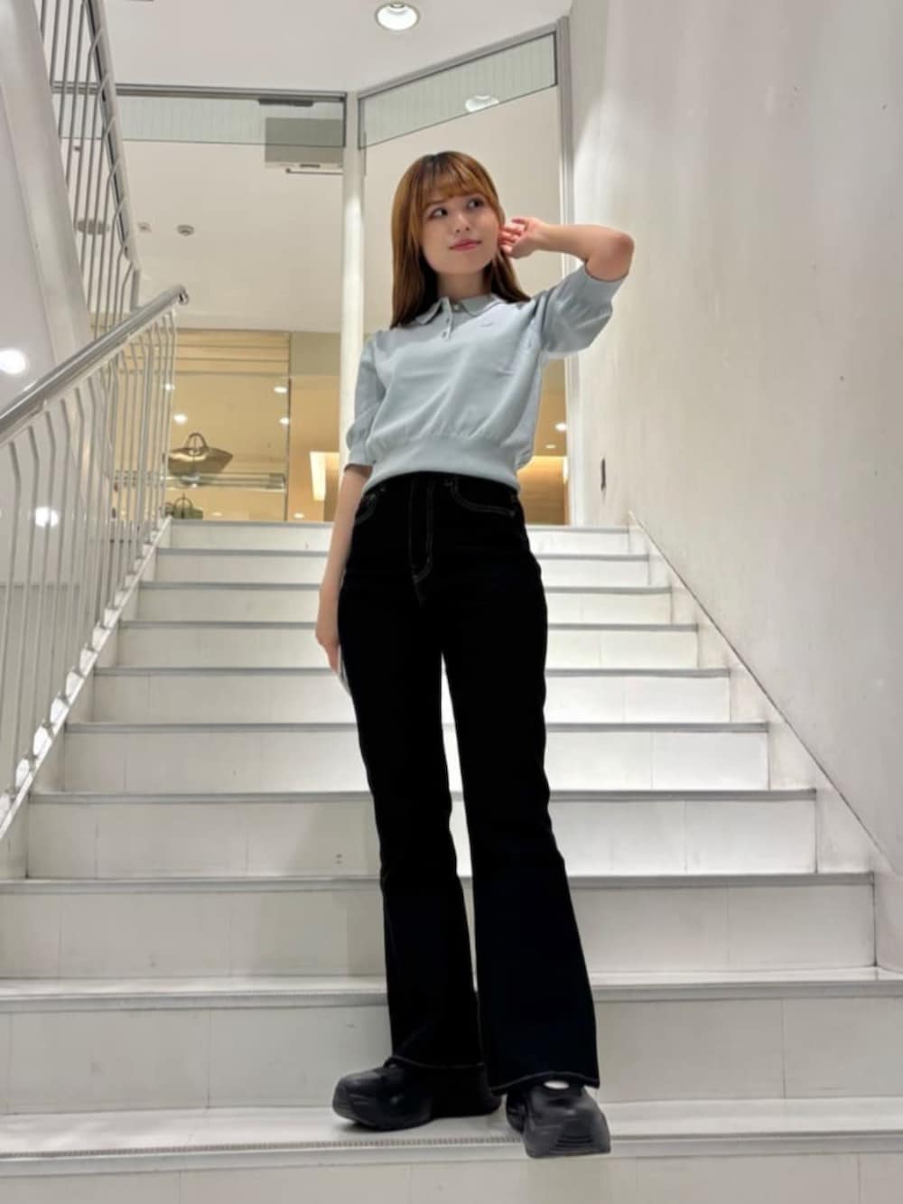 グリーン系のポロシャツを着用したレディースの春コーディネートの2枚目の写真