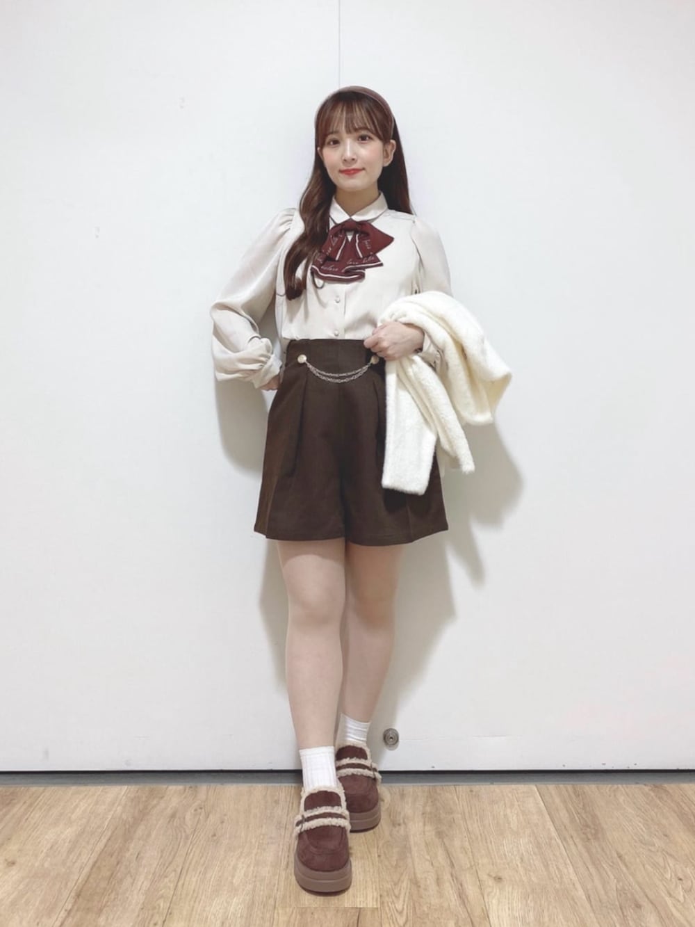 ブラウン系のその他パンツ、ブラウン系のモカシン/デッキシューズ、ベージュ系のシャツ/ブラウスを着用したレディースの秋コーディネートの2枚目の写真