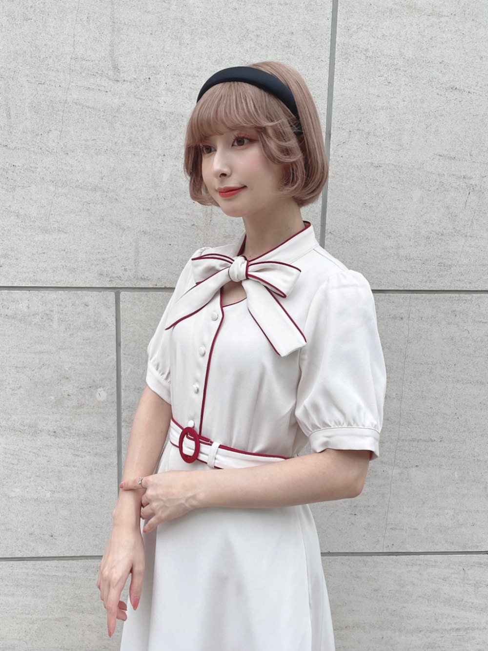 ホワイト系のワンピース、ブラック系のカチューシャを着用したレディースの春コーディネートの2枚目の写真