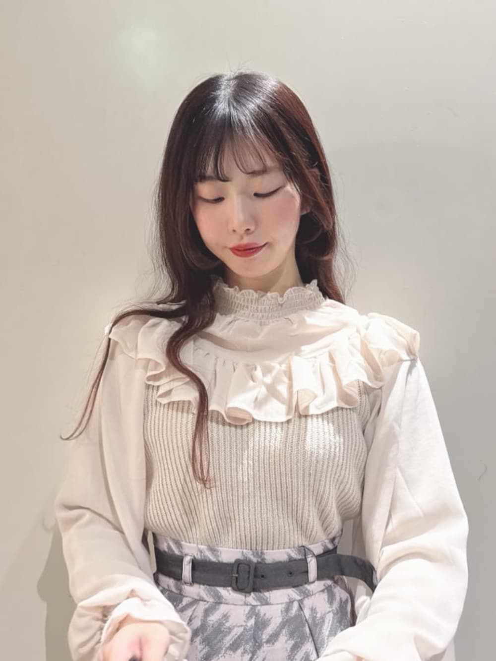 グレー系のスカート、グレー系のトートバッグ、グレー系のパンプスを着用したレディースの秋コーディネートの2枚目の写真