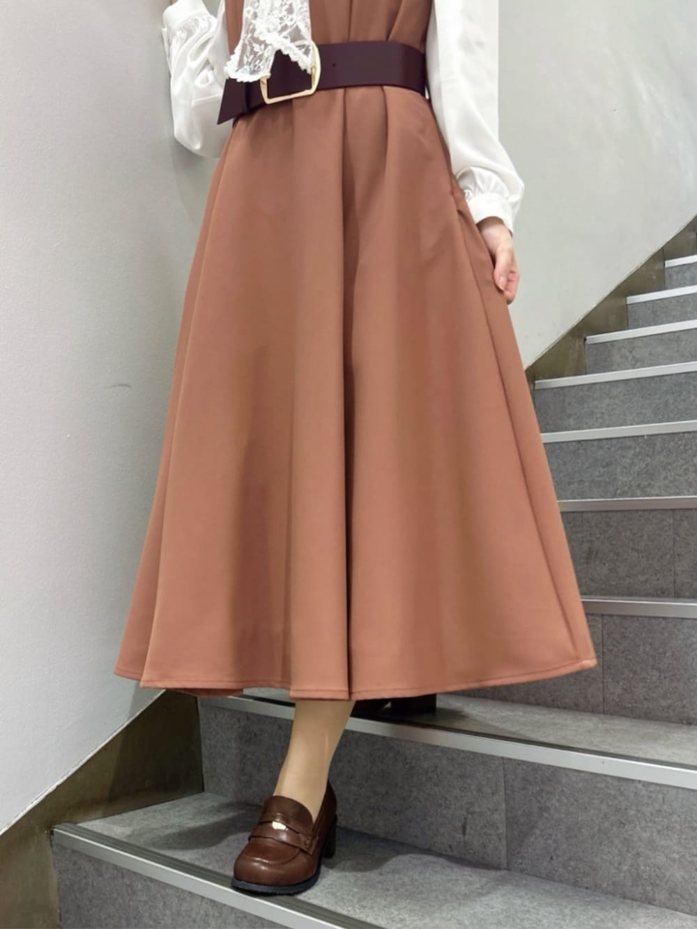 ブラウン系のローファー、ホワイト系のシャツ/ブラウス、レッド系のワンピースを着用したレディースの冬コーディネートの2枚目の写真