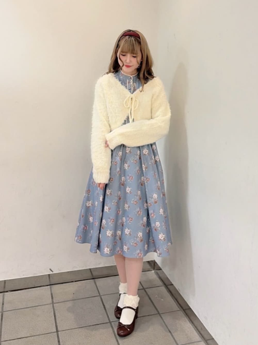 ブラウン系のバレエシューズ、グレー系のワンピース、ホワイト系のカーディガン/ボレロを着用したレディースの冬コーディネートの2枚目の写真