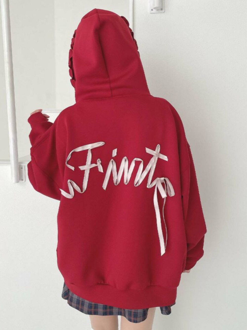 ブラウン系のブーツ、レッド系のパーカー、ブルー系のスカートを着用したレディースの秋コーディネートの3枚目の写真