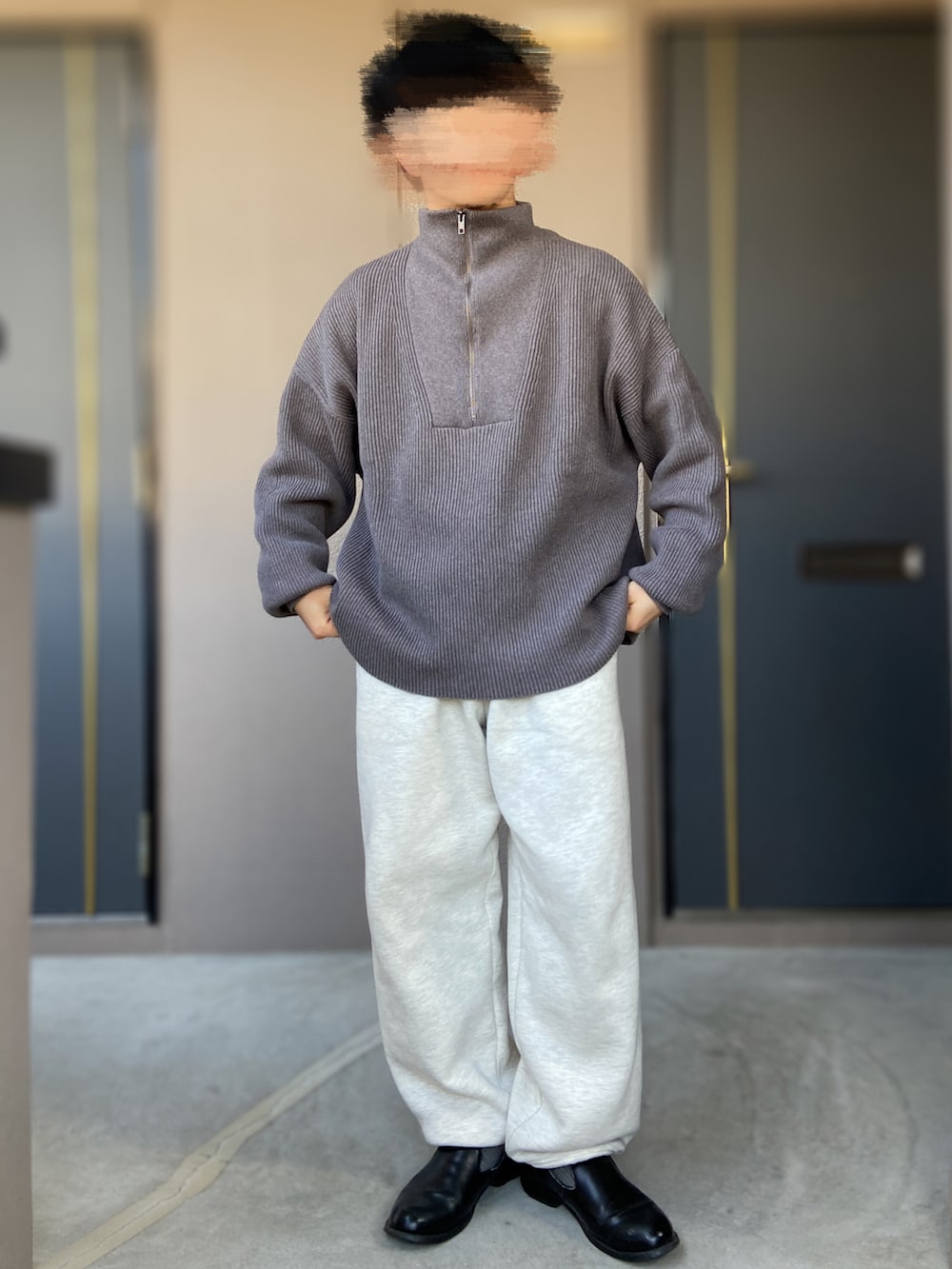 グレー系のスウェットパンツ、ブラック系のベスト、グレー系のニット/セーターを着用したメンズの冬コーディネートの2枚目の写真