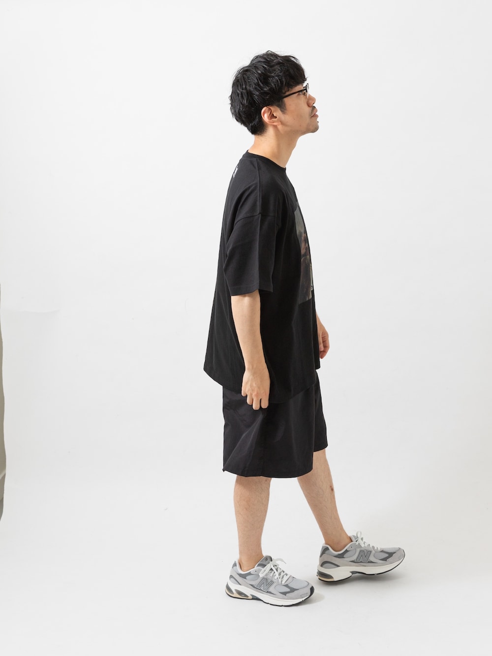 ブラック系のTシャツ/カットソー、ブラック系のその他パンツ、グレー系のスニーカーを着用したメンズの夏コーディネートの6枚目の写真