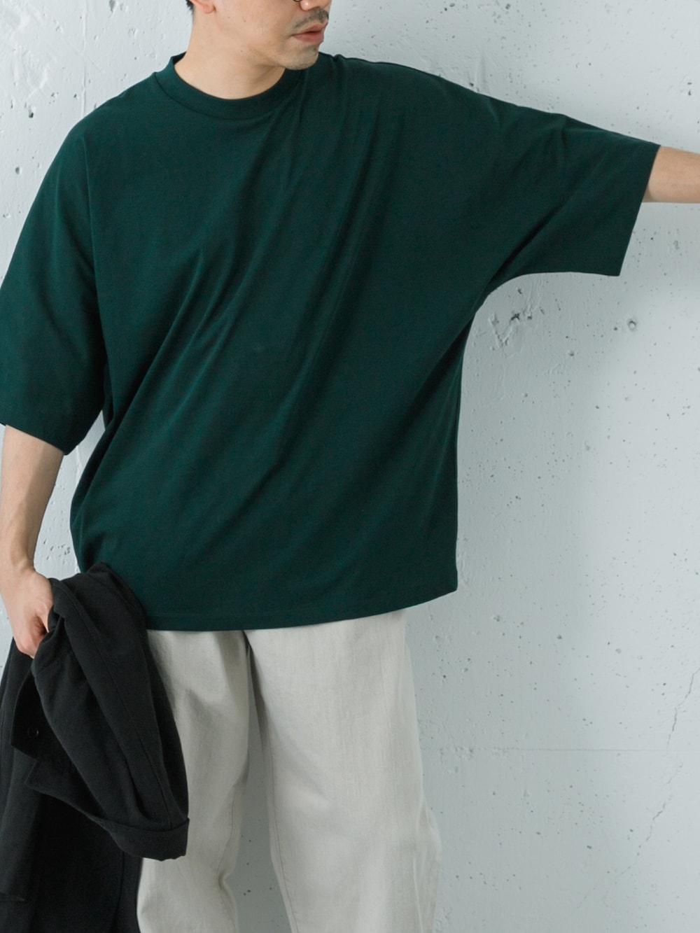 ブラック系のローファー、グリーン系のTシャツ/カットソー、ベージュ系のデニムパンツを着用したメンズの春コーディネートの5枚目の写真