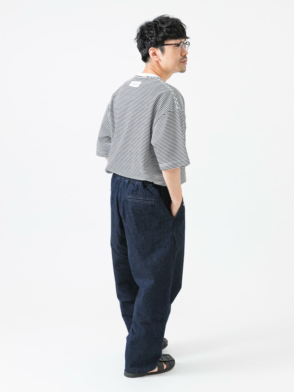 ホワイト系のTシャツ/カットソー、ブルー系のデニムパンツを着用したメンズの夏コーディネートの5枚目の写真